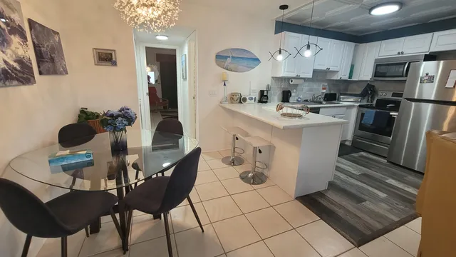 a kitchen with stainless steel appliances kitchen island granite countertop a sink and cabinets