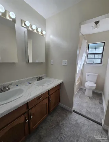 a kitchen with cabinets appliances a sink and a counter top