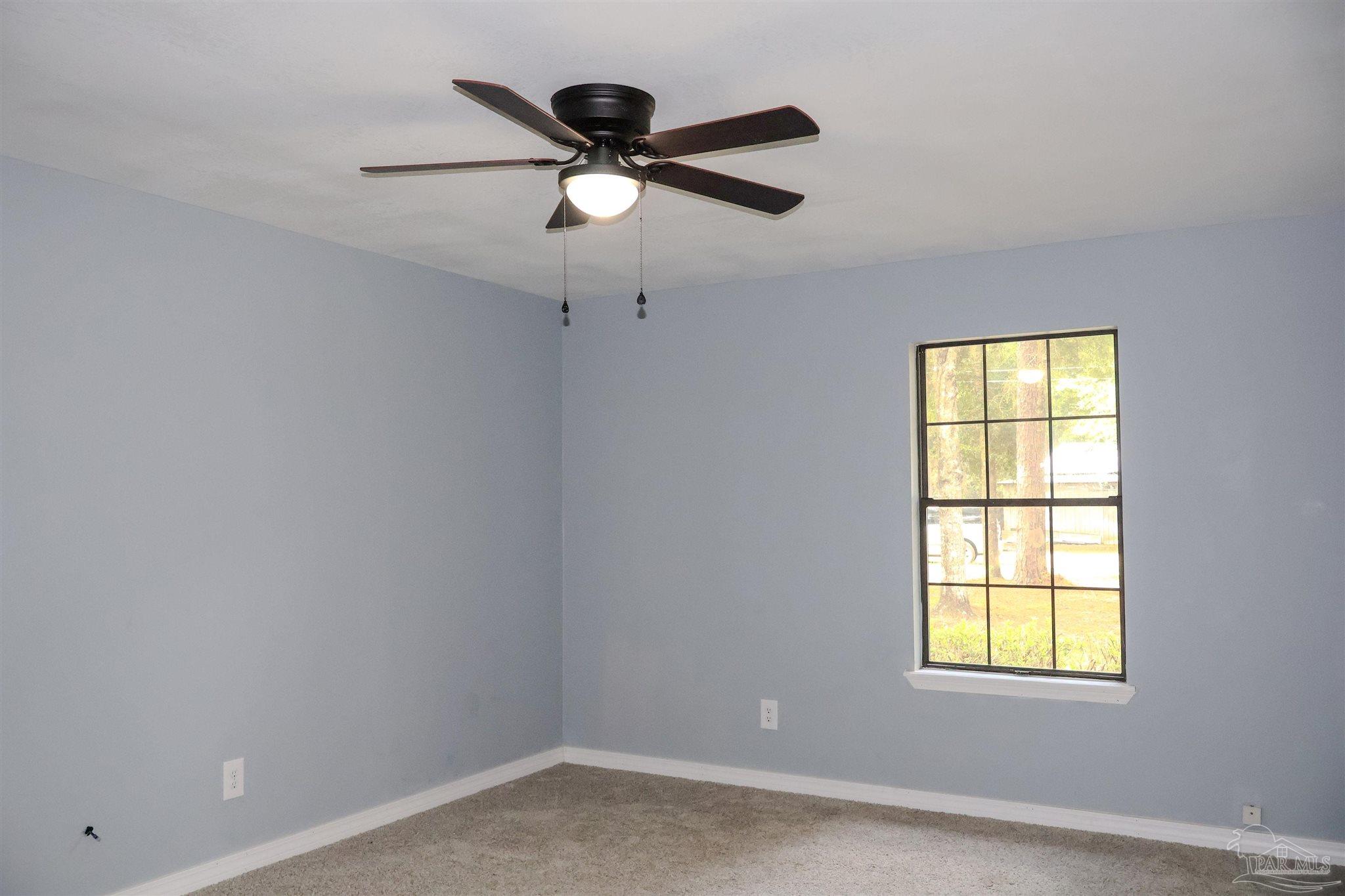111 Cotton Creek Road McDavid, FL 32568 - Photo 13 of 30 an empty room with a window and a fan