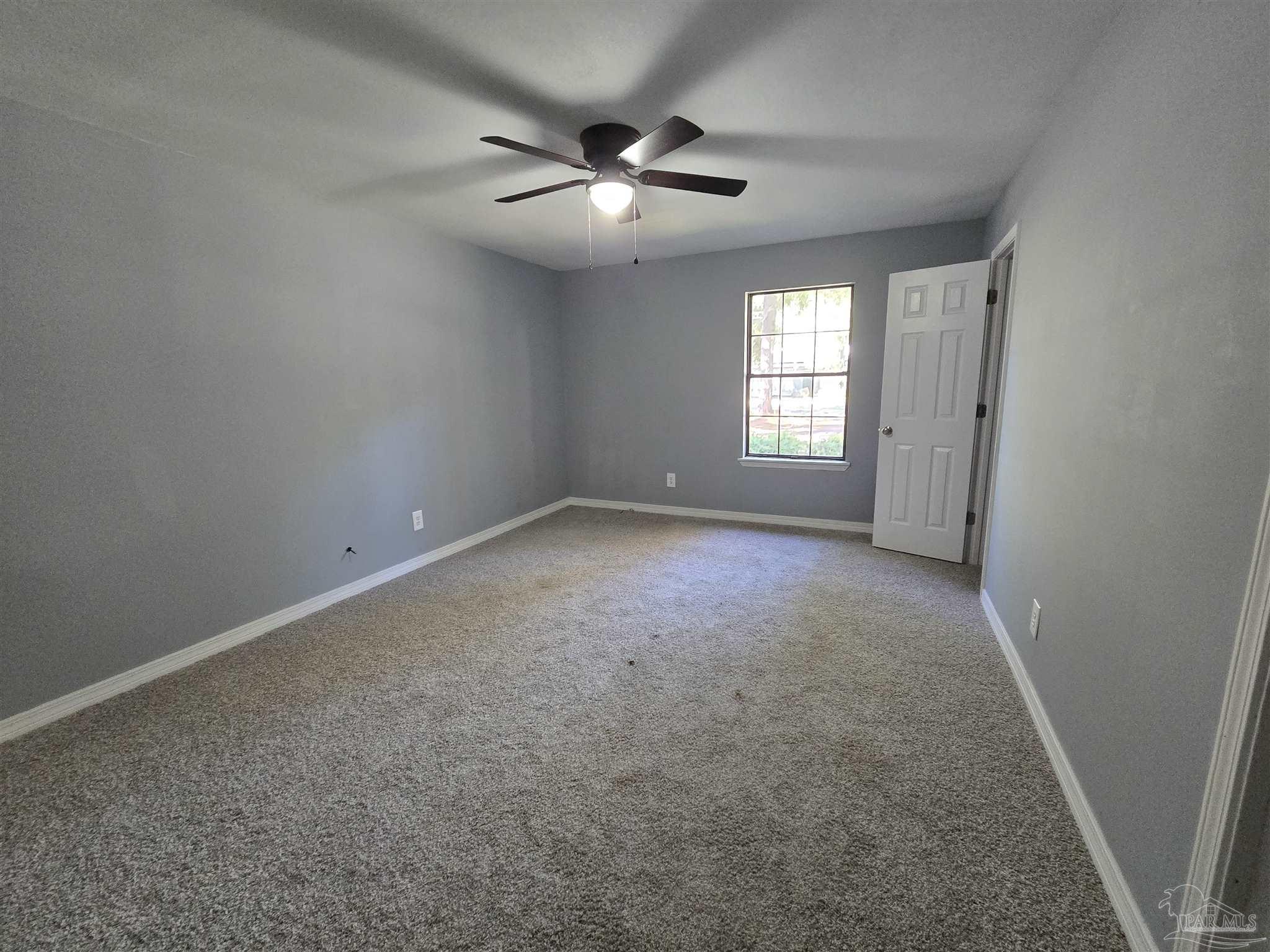 111 Cotton Creek Road McDavid, FL 32568 - Photo 14 of 30 en empty room with windows and ceiling fan