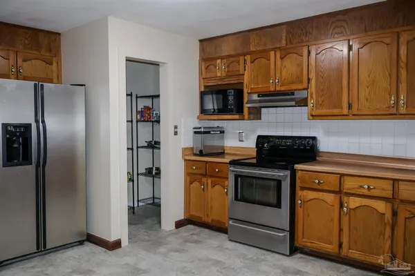a kitchen with stainless steel appliances granite countertop a stove and a refrigerator