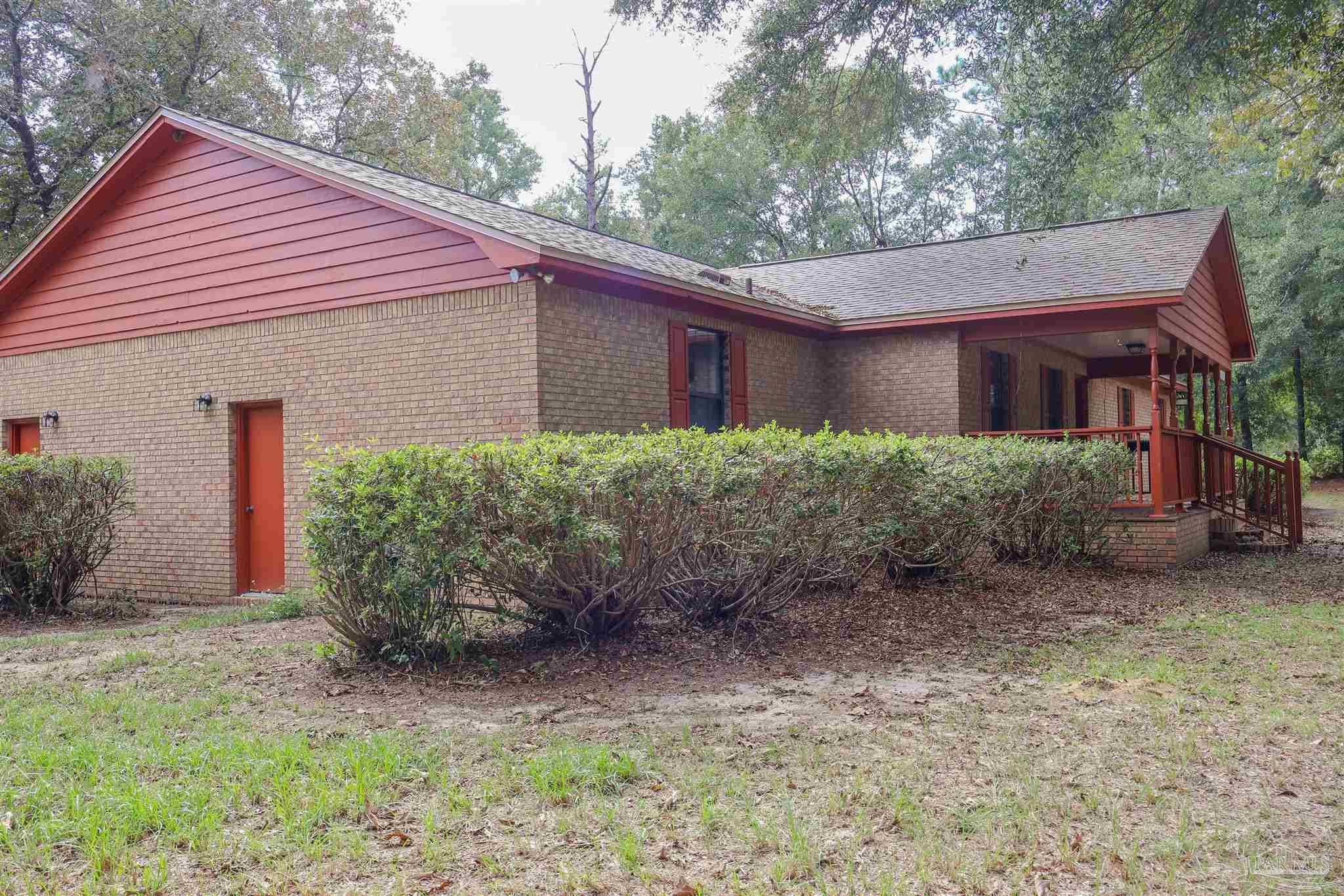 111 Cotton Creek Road McDavid, FL 32568 - Photo 30 of 30 a view of a house with a yard and plants