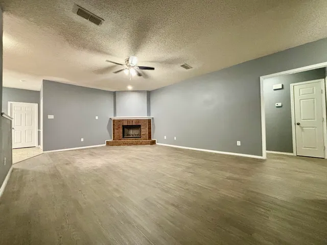 a view of a livingroom with a ceiling fan window and a chandelier