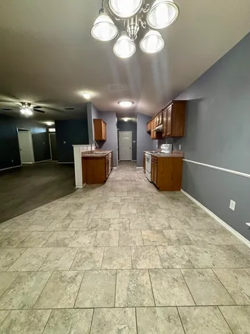 a large room with kitchen view