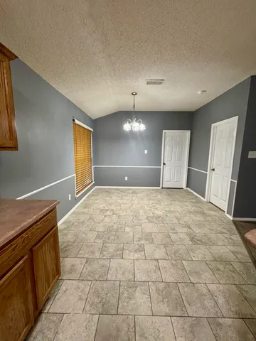a kitchen with a sink a stove and cabinets