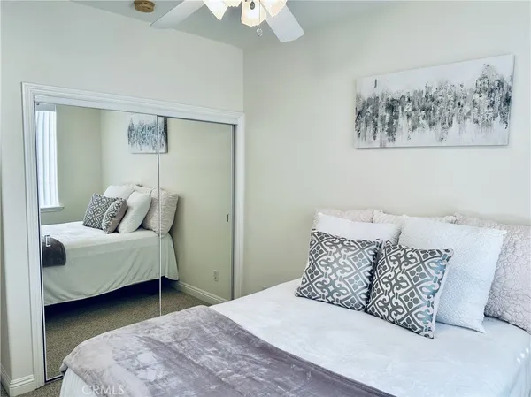 a bathroom with a granite countertop sink toilet and a mirror