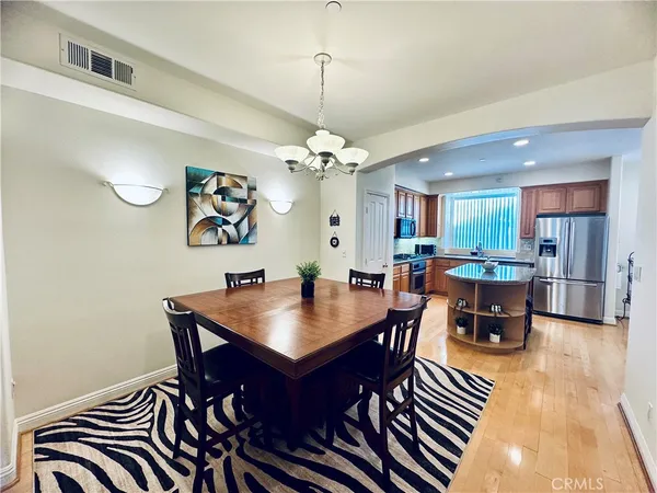 a view of a dining room with furniture and chandelier