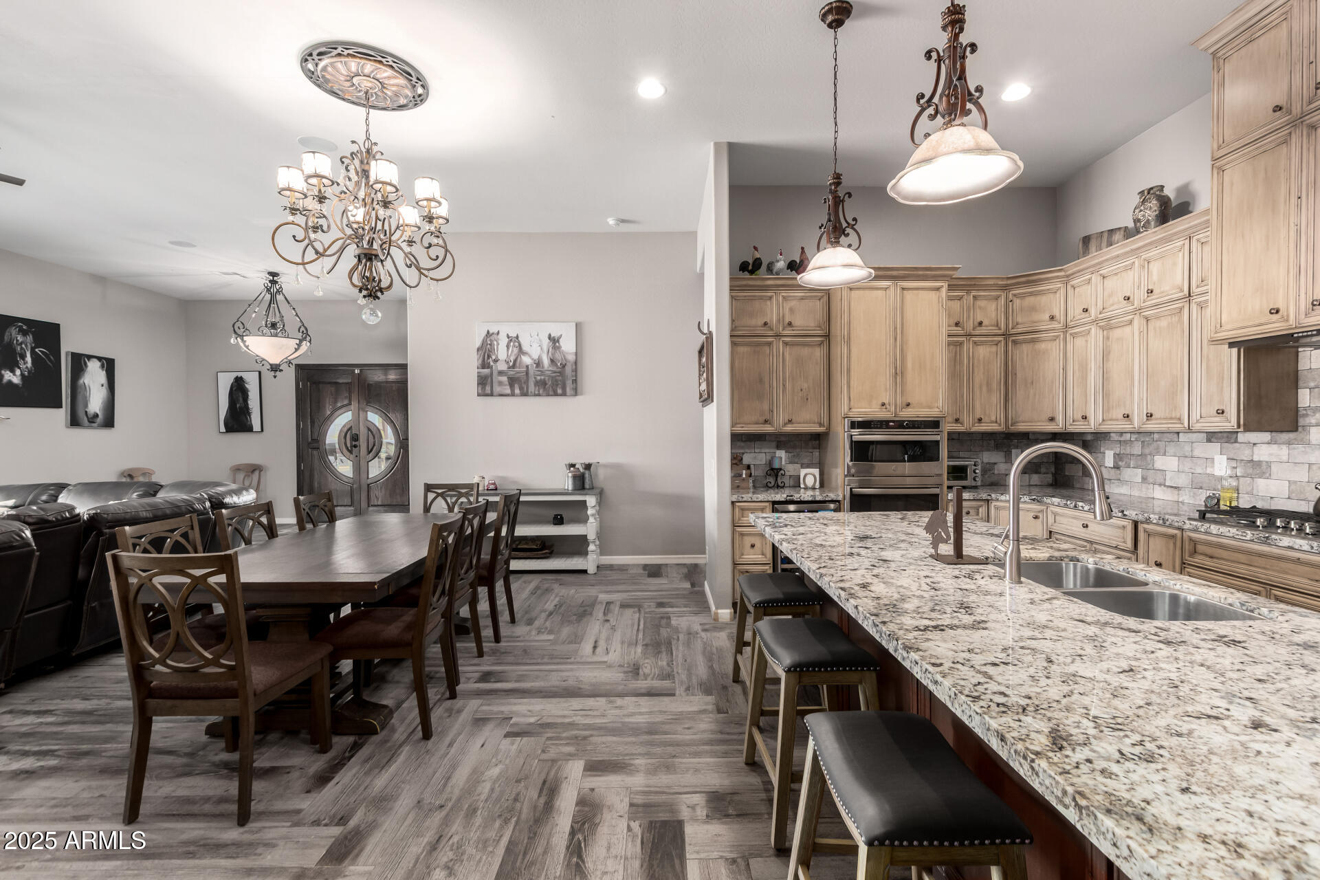 17024 East Lone Mountain Road Rio Verde, AZ 85263 - Photo 12 of 42 a view of a dining room with furniture a chandelier and wooden floor