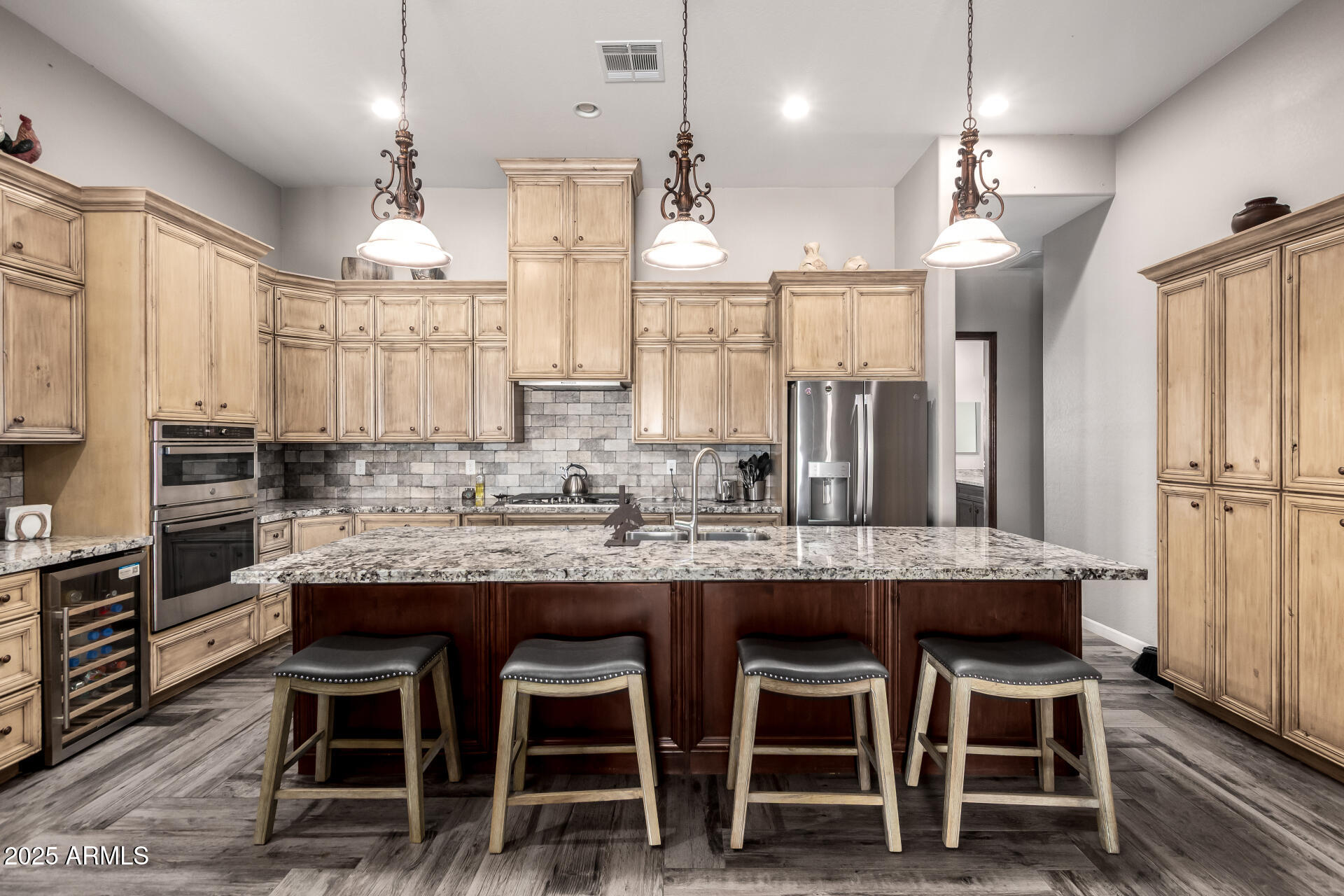 17024 East Lone Mountain Road Rio Verde, AZ 85263 - Photo 14 of 42 a kitchen with kitchen island granite countertop a table chairs sink and cabinets