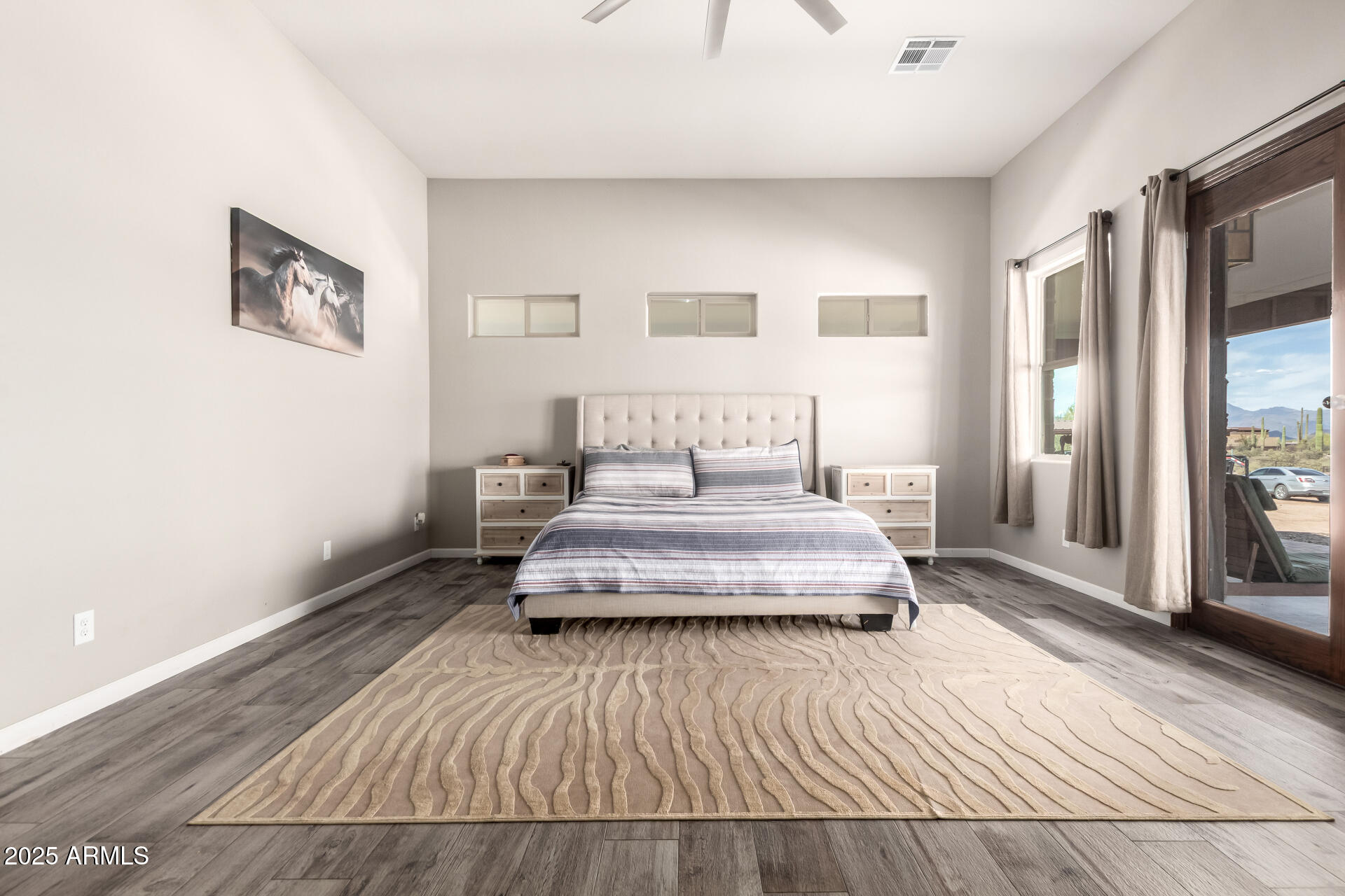17024 East Lone Mountain Road Rio Verde, AZ 85263 - Photo 22 of 42 a bedroom with a bed and wooden floor