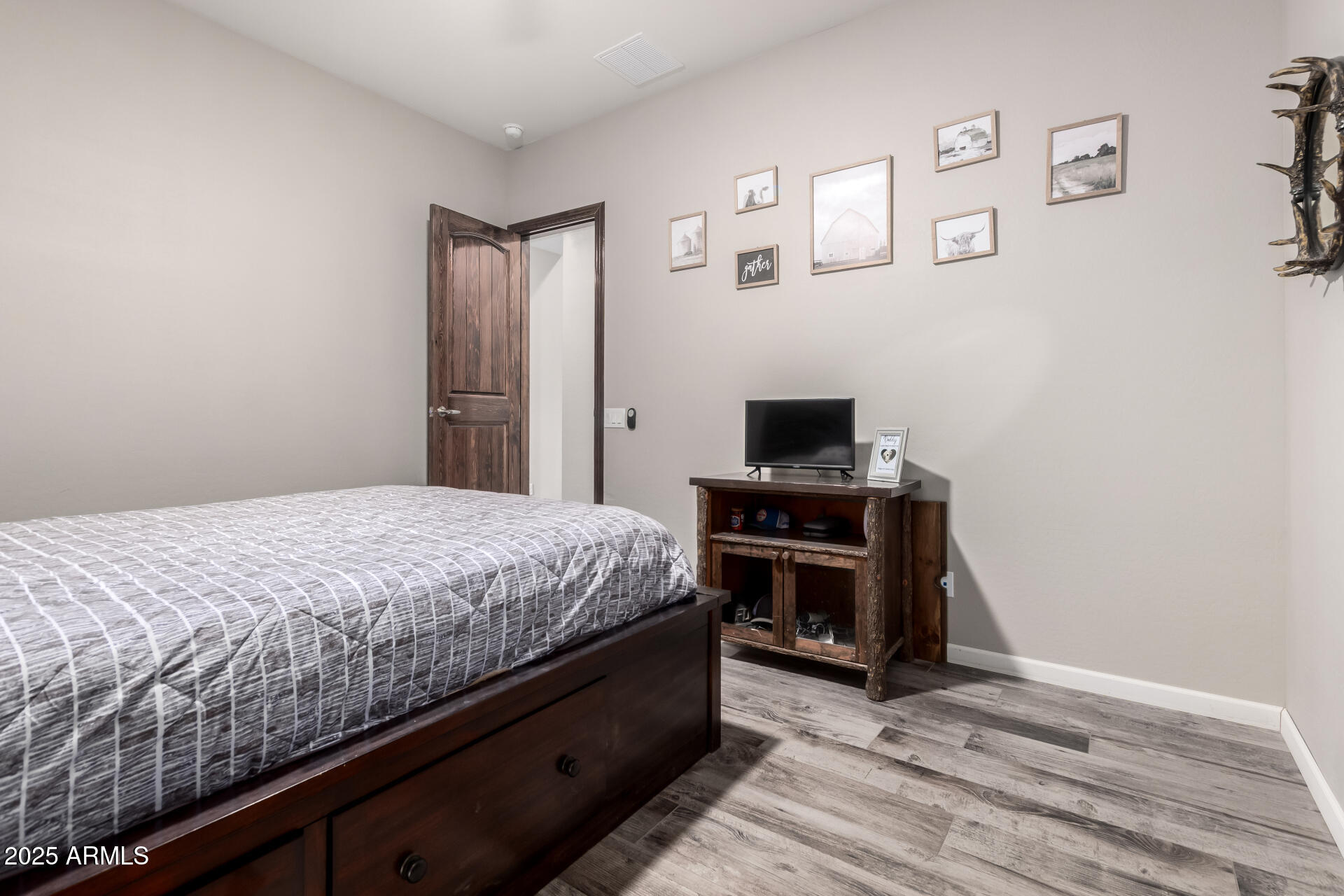 17024 East Lone Mountain Road Rio Verde, AZ 85263 - Photo 31 of 42 a bedroom with a bed and a flat screen tv