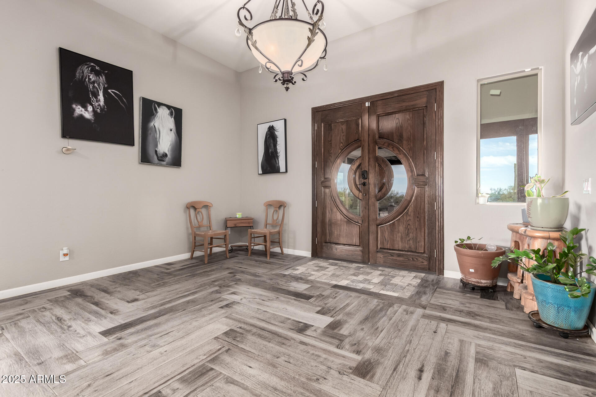 17024 East Lone Mountain Road Rio Verde, AZ 85263 - Photo 7 of 42 a bedroom with a bed and a chandelier