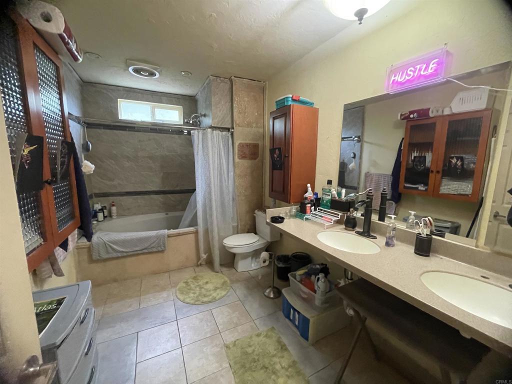 9141-43 Campo Road Spring Valley, CA 91977 - Photo 18 of 26 a bathroom with a sink a toilet and shower