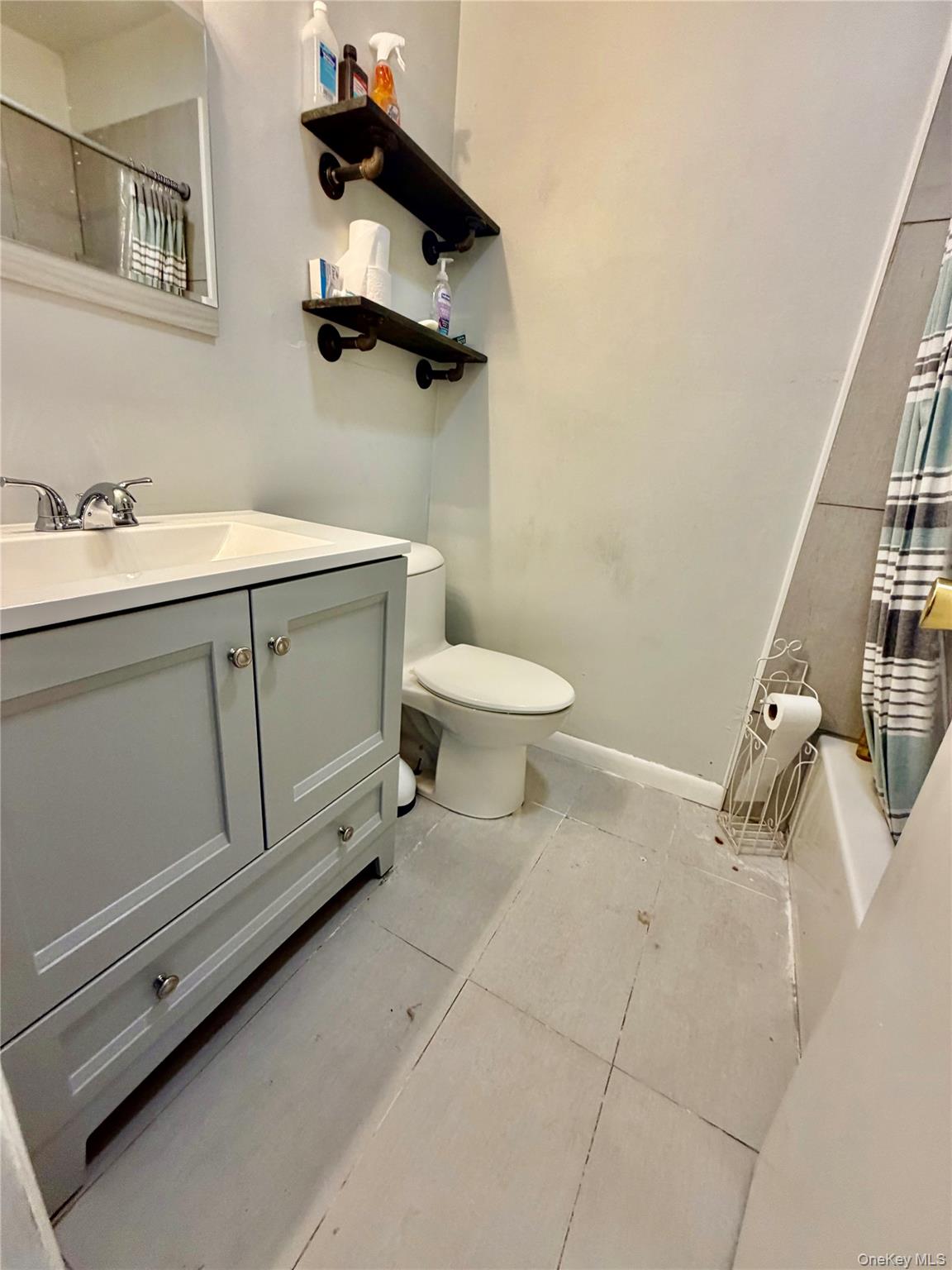26 Cooper Road, Unit 312 Poughkeepsie, NY 12603 - Photo 6 of 13 a bathroom with a toilet sink and mirror