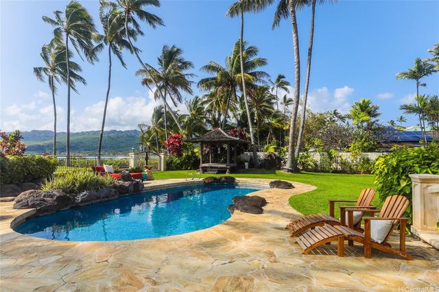 a view of a swimming pool with lounge chair