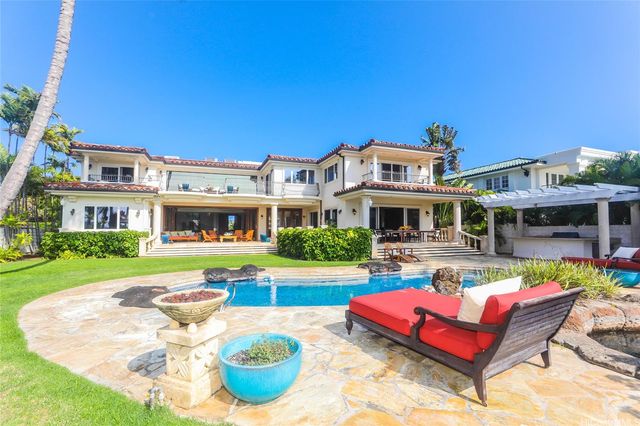 a front view of house with yard and outdoor seating