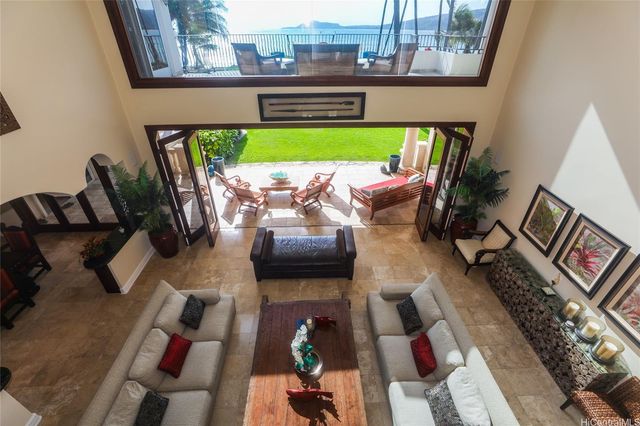 an outdoor living room with furniture and a wooden floor