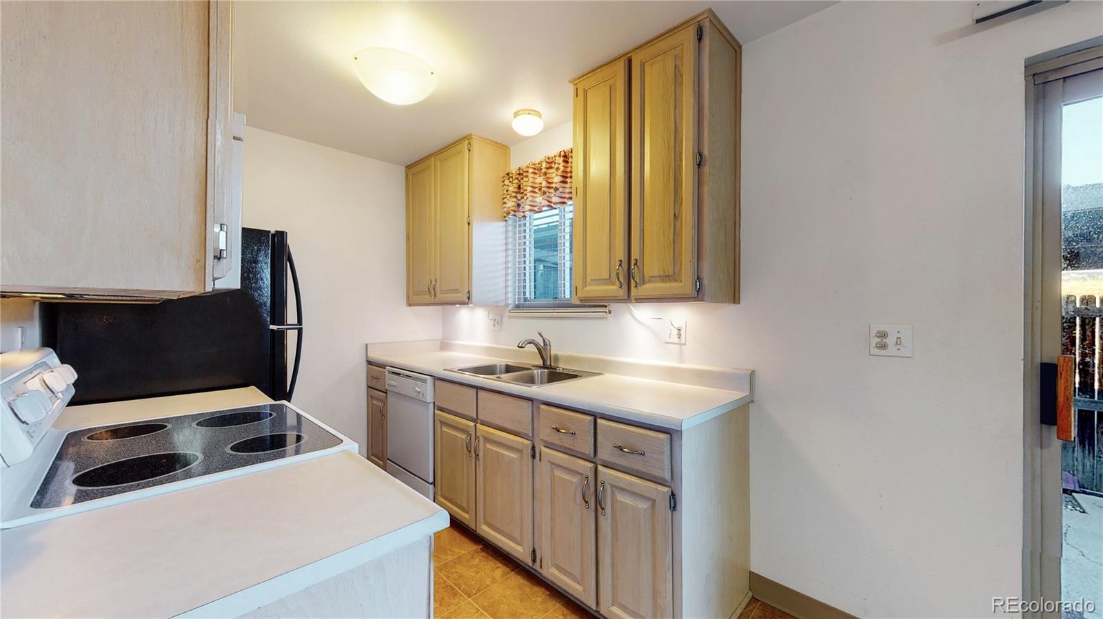 223 Holman Way Golden, CO 80401 - Photo 6 of 29 a kitchen with a sink and a refrigerator