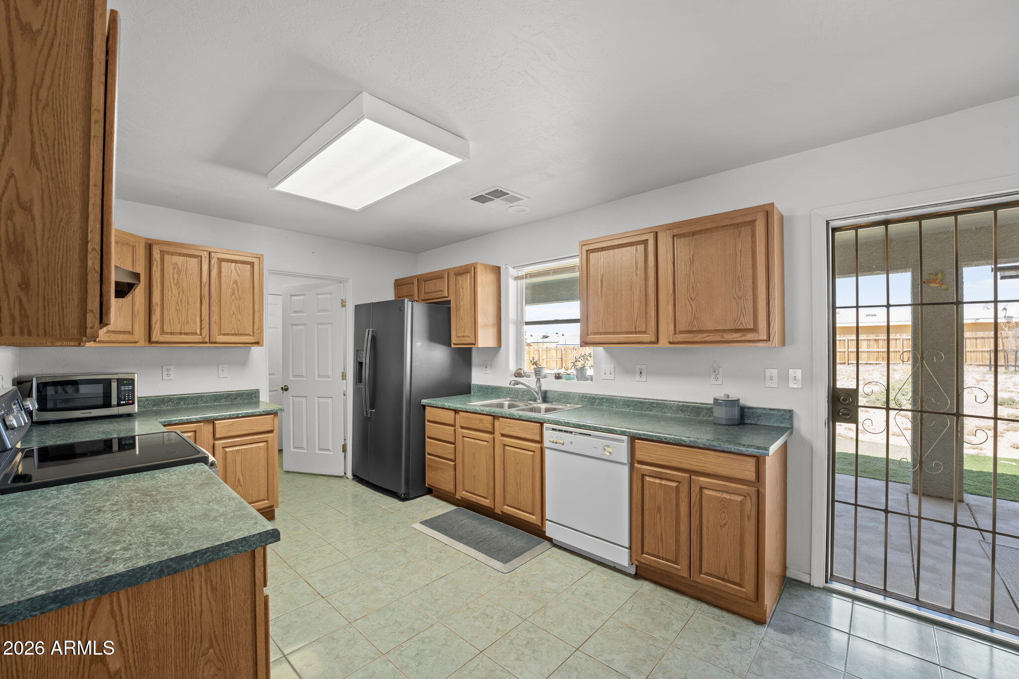 27144 Bennett Way Congress, AZ 85332 - Photo 14 of 33 a kitchen with stainless steel appliances granite countertop a stove sink and cabinets
