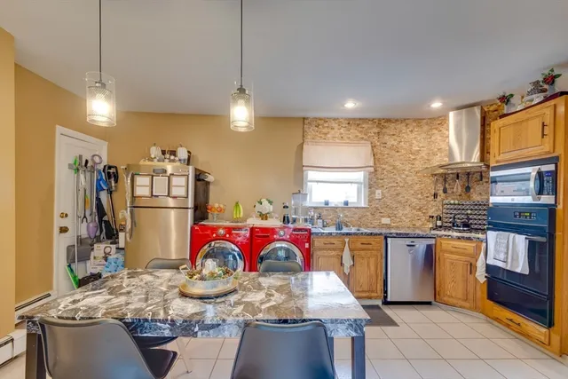 a kitchen with stainless steel appliances granite countertop sink stove top oven and cabinets