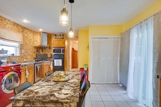 a kitchen with sink refrigerator and stove