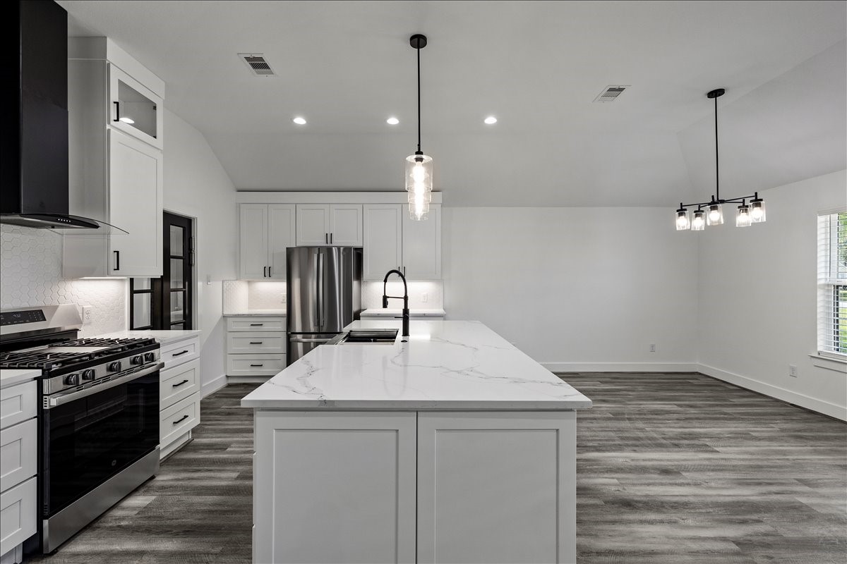 14103 3rd Street Santa Fe, TX 77517 - Photo 12 of 46 a kitchen with kitchen island a sink stainless steel appliances and cabinets