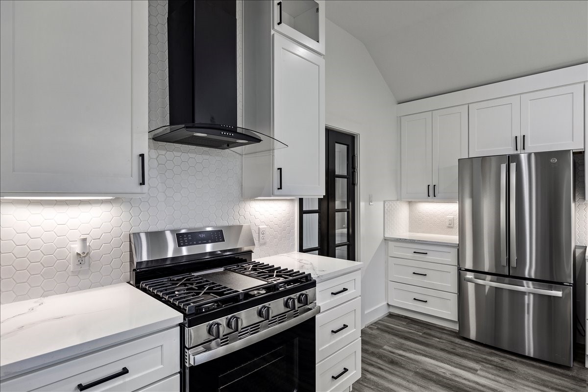 14103 3rd Street Santa Fe, TX 77517 - Photo 15 of 46 a kitchen with stainless steel appliances granite countertop a stove and a refrigerator
