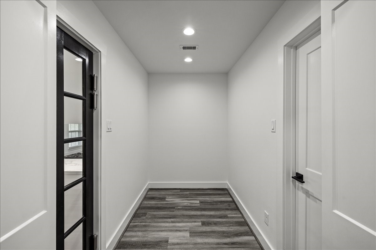 14103 3rd Street Santa Fe, TX 77517 - Photo 19 of 46 a view of a hallway with wooden floor and staircase