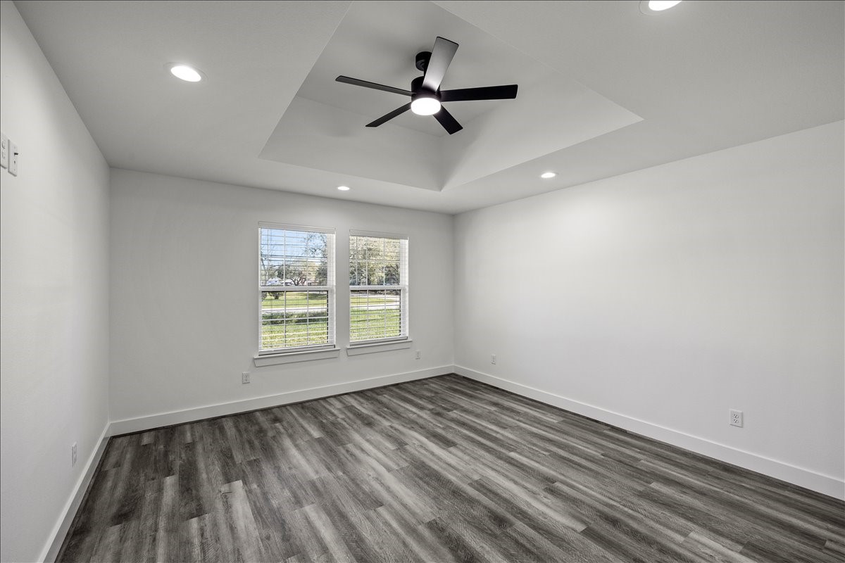 14103 3rd Street Santa Fe, TX 77517 - Photo 21 of 46 a view of empty room with wooden floor and fan