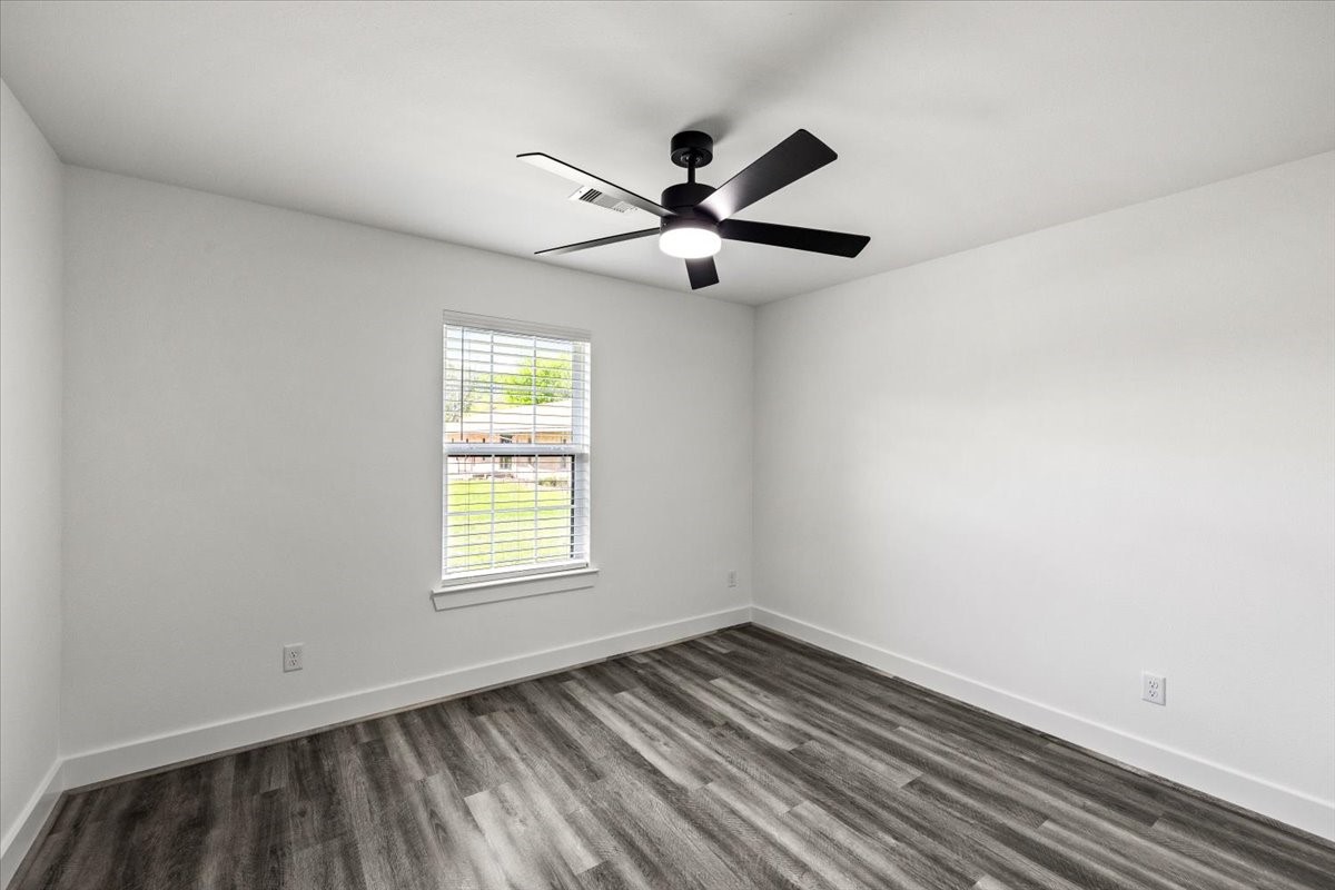 14103 3rd Street Santa Fe, TX 77517 - Photo 30 of 46 a view of empty room with wooden floor and fan