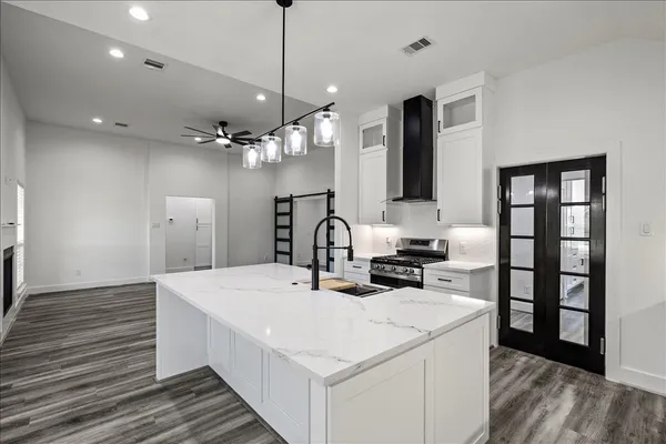 an empty room with windows and a fireplace