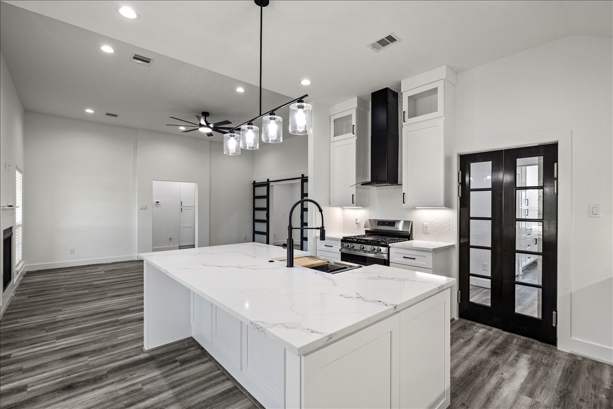 14103 3rd Street Santa Fe, TX 77517 - Photo 3 of 46 a large white kitchen with sink and refrigerator