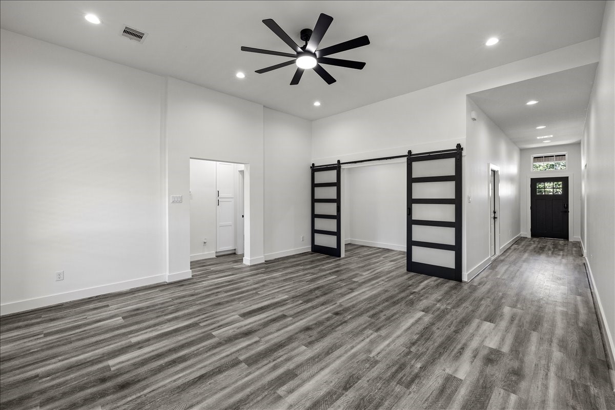 14103 3rd Street Santa Fe, TX 77517 - Photo 4 of 46 wooden floor in an empty room with a window