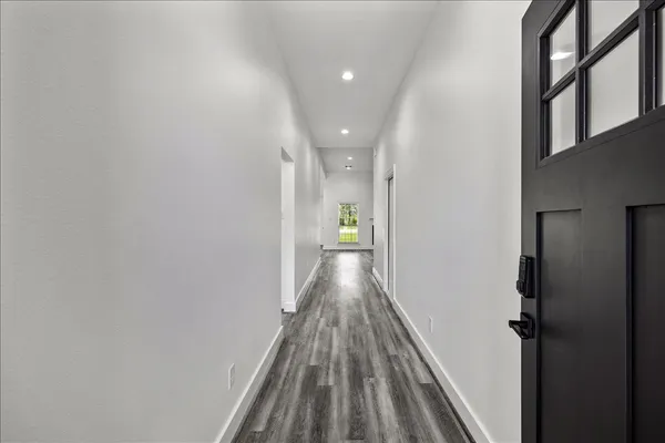 a view of a room with wooden floor