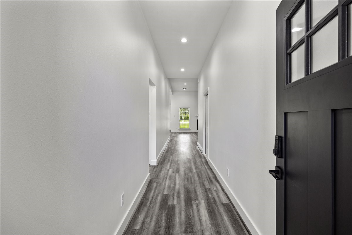 14103 3rd Street Santa Fe, TX 77517 - Photo 6 of 46 a view of a hallway with wooden floor and staircase