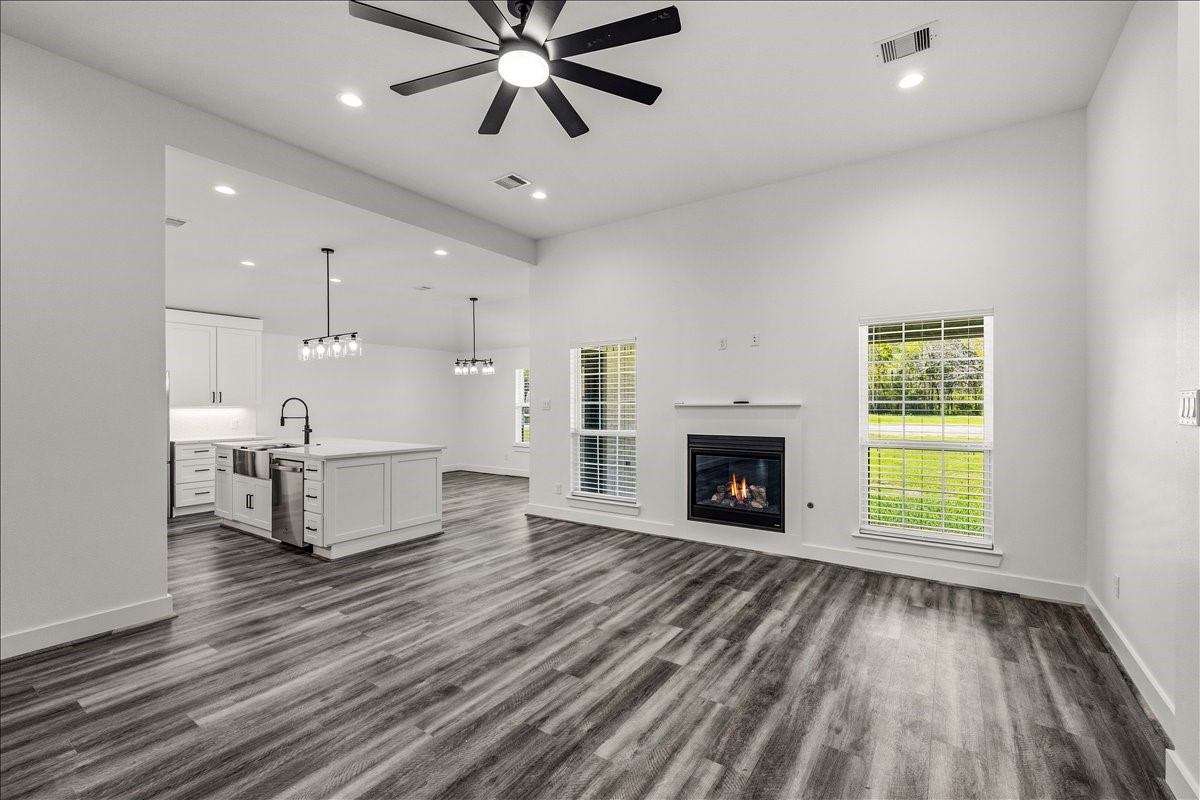14103 3rd Street Santa Fe, TX 77517 - Photo 9 of 46 a view of an empty room with a fireplace and window