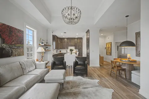 a living room with furniture and kitchen view