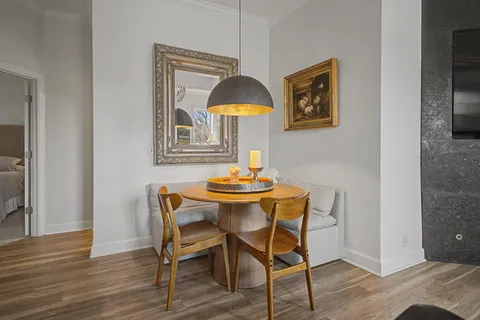 a dining room with furniture and wooden floor