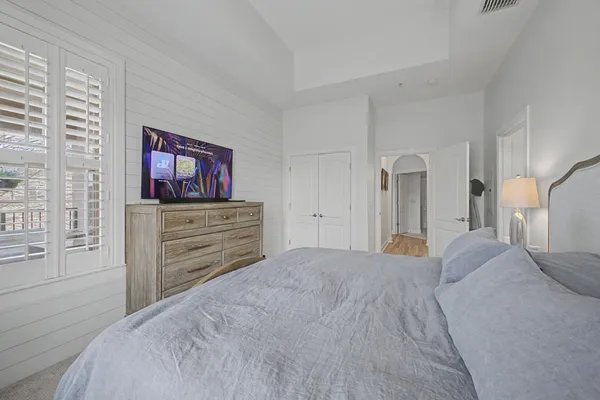 a bedroom with a bed and a dresser