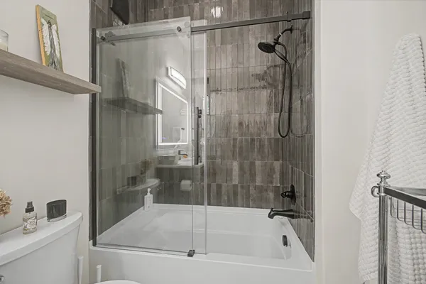 a bathroom with a bathtub and a shower