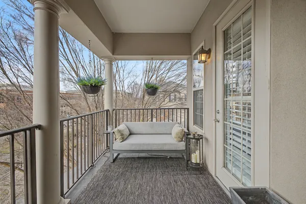 a view of a balcony with furniture