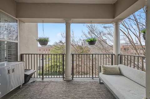 a view of a balcony with furniture