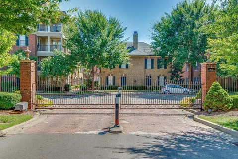 a view of a house with a yard and large tree