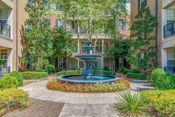 a view of a house with a fountain and a fountain in front of a house