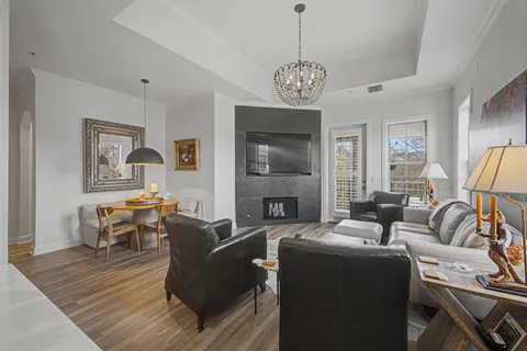 a living room with furniture or couch and a chandelier
