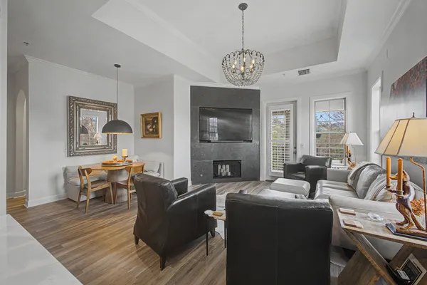 a living room with furniture or couch and a chandelier
