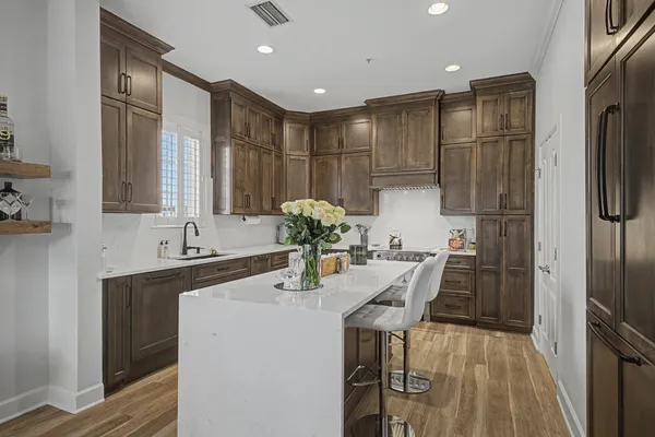 a kitchen with refrigerator and sink