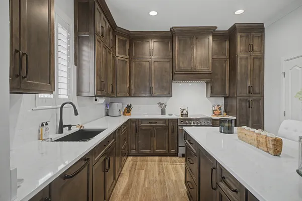a kitchen with a sink a stove and cabinets