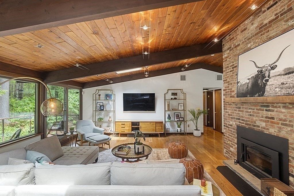 127 Commerford Road Concord, MA 01742 - Photo 13 of 33 a living room with furniture a fireplace and a flat screen tv