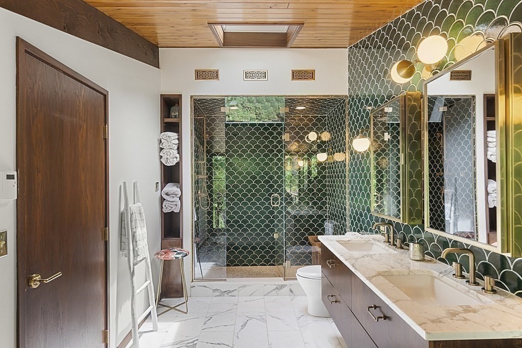 127 Commerford Road Concord, MA 01742 - Photo 15 of 33 a bathroom with a granite countertop sink a toilet and shower